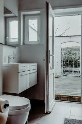 a bathroom with a toilet and a sink and a window at Cosy Apartment with Big Quiet & Sunny terras in Ghent