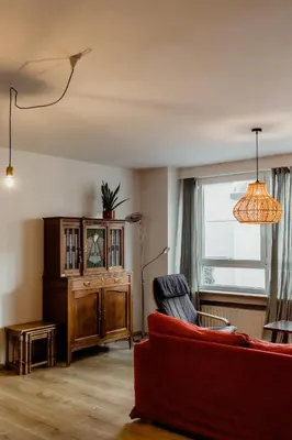a living room with a red couch and a window at Cosy Apartment with Big Quiet & Sunny terras in Ghent