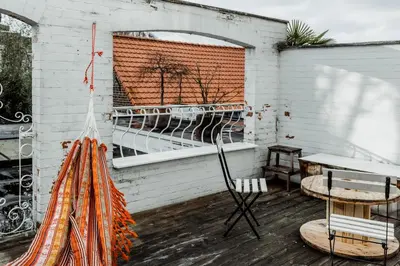 a patio with a table and chairs and a window at Cosy Apartment with Big Quiet & Sunny terras in Ghent