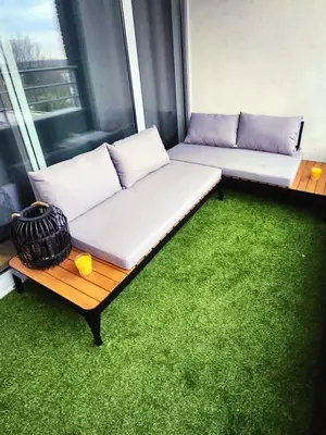 a white couch sitting in a room with green carpet at BRUSSELS EXPO APARTMENT in Brussels