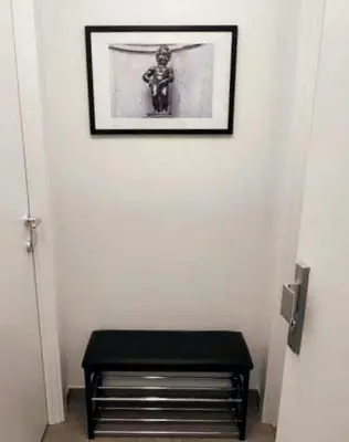 a black stool in a room with a picture on the wall at BRUSSELS EXPO APARTMENT in Brussels
