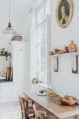 a kitchen with a wooden table with chairs and a mirror at Bleyckhof in een uniek natuurgebied in Ranst