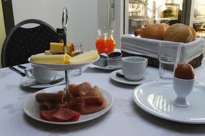 a table with plates of food on a table at De Kasteelhoeve in Westmalle