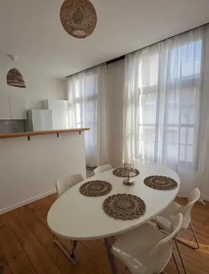 a white dining room with a white table and chairs at B&B Art and Sleep in Antwerp