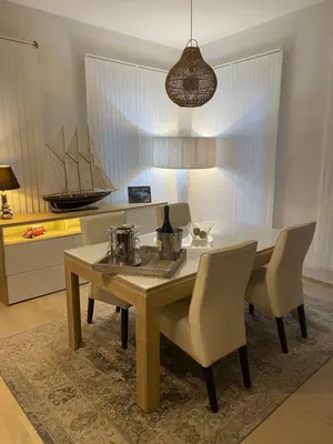 a dining room with a table and chairs and a boat at B&B Art and Sleep in Antwerp