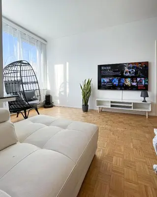 a living room with a white couch and a flat screen tv at Cosy two bedroom apartment in Brussels in Brussels