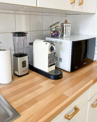 a kitchen counter with a blender and a microwave at Cosy two bedroom apartment in Brussels in Brussels