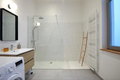 a bathroom with a shower and a sink and a mirror at South Cosy Residence in Brussels