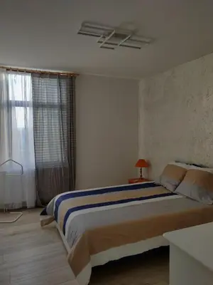a bedroom with a large bed and a window at Mathilde in Brussels