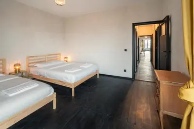 a bedroom with two beds and a hallway at Two-Bedroom Apartments in the Heart of Antwerp in Antwerp