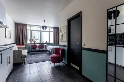 a hotel room with a kitchen and a living room at Hey - Aparthotel Brussels in Brussels