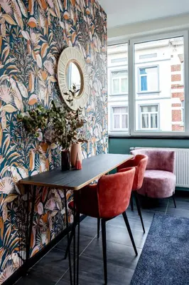 a dining room with a table and a mirror at Hey - Aparthotel Brussels in Brussels