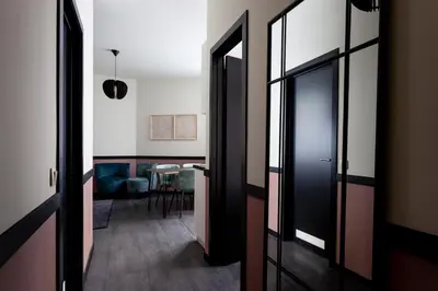 a hallway with two doors and a table in a room at Hey - Aparthotel Brussels in Brussels