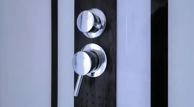two metal knobs on a wall in a room at Logeerkamer XXL 25 m2 in Zemst