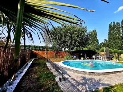 a swimming pool in a yard with benches around it at Luxury Pop Up Camping & Hotel Package & Private Transport to Tomorrowland in Schelle