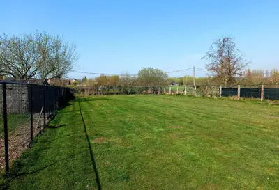 a fenced in field with a fence and grass at Luxury Pop Up Camping & Hotel Package & Private Transport to Tomorrowland in Schelle