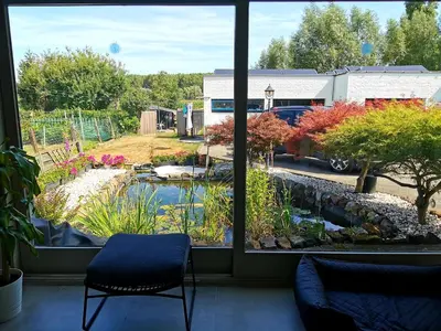 a view of a garden from a window at Luxury Pop Up Camping & Hotel Package & Private Transport to Tomorrowland in Schelle