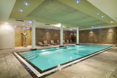 a large swimming pool in a hotel room at Luxury Pop Up Camping & Hotel Package & Private Transport to Tomorrowland in Schelle