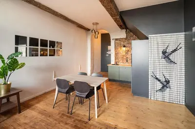 a kitchen and dining room with a table and chairs at Two-Bedroom River Side Apartment in the Heart of Antwerp in Antwerp