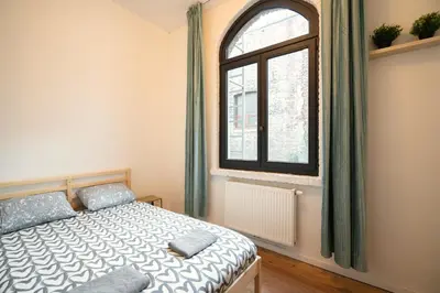 a bedroom with a bed and a window at Two-Bedroom River Side Apartment in the Heart of Antwerp in Antwerp