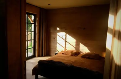 a bedroom with a bed in a room with a window at Huis van luut in Tielt
