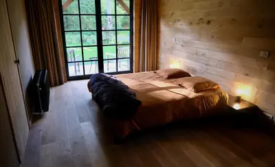 a bedroom with a bed in a room with a window at Huis van luut in Tielt