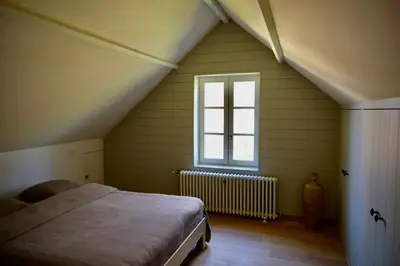 a bedroom with a bed and a window at Huis van luut in Tielt