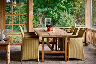 a wooden table and chairs on a patio at Huis van luut in Tielt