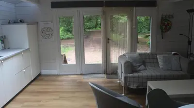 a kitchen and living room with a couch and a table at Mezenhof in Brasschaat