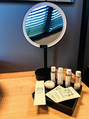a table with a mirror and four bottles of medicine at B&B 't Kloosterveld in Boutersem