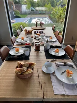 a wooden table with food on top of it at B&B 't Kloosterveld in Boutersem