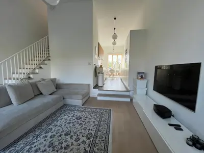 a living room with a couch and a flat screen tv at Luxury apartment, private terrace & FREE PARKING in Antwerp