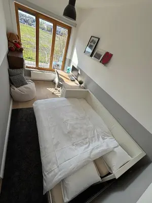 a large bed in a room with a window at Luxury apartment, private terrace & FREE PARKING in Antwerp