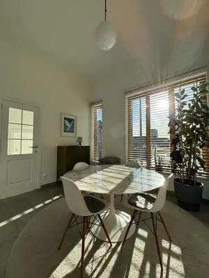 a dining room with a glass table and two chairs at Luxury apartment, private terrace & FREE PARKING in Antwerp