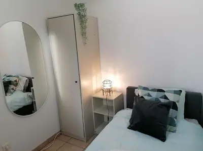 a small bedroom with a bed and a mirror at The Corner in Retie