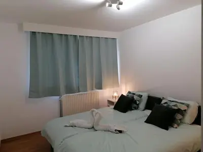 a bedroom with two beds and a window at The Corner in Retie