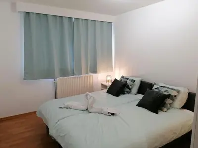 a large white bed in a room with a window at The Corner in Retie