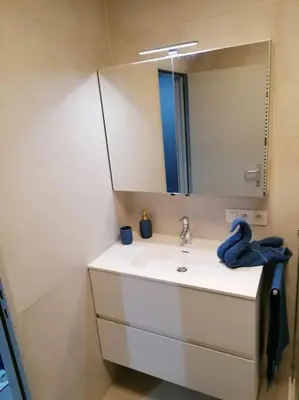 a bathroom with a white sink and a mirror at The Corner in Retie