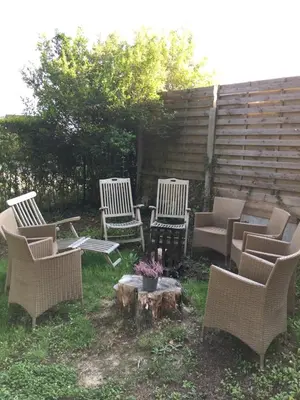 a group of chairs and a table and a tree stump at Overijse’s cosiest double room in Overijse