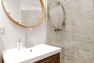 a bathroom with a sink and a mirror and a shower at Cozy Apartment in Brussels in Brussels