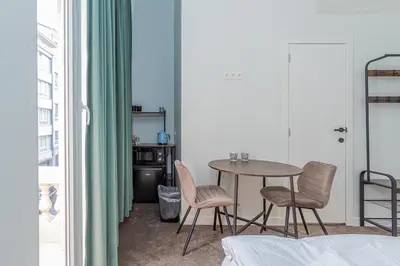 a dining room with a table and two chairs at Studio Anvers in Antwerp