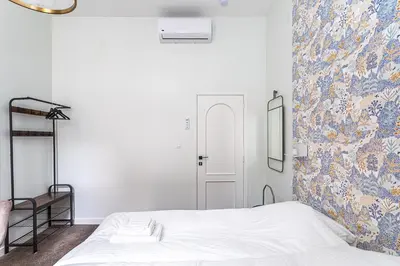 a bedroom with a bed and a floral wall at Studio Anvers in Antwerp