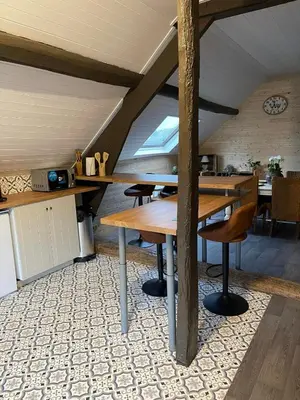 a room with a table and chairs in a attic at Sweet Dreams by Pegase in Vlezenbeek