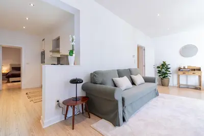 a living room with a couch and a table at Bright, Spacious Apartments & Perfectly Located in the Heart of Ghent in Ghent