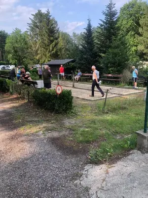 a group of people walking around a park at Camping het Swinnenbos in Diest