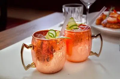 two drinks in copper mugs on a table at Camping het Swinnenbos in Diest