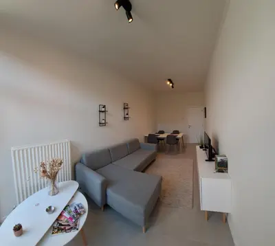 a living room with a couch and a table at Huis ALNA 3 in Mechelen