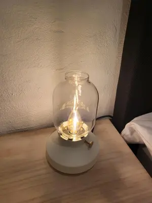 a glass jar with a light on a table at Huis ALNA 3 in Mechelen