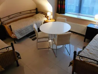 a bedroom with a bed and a table and chairs at loft/appartement golden dragon in Dessel