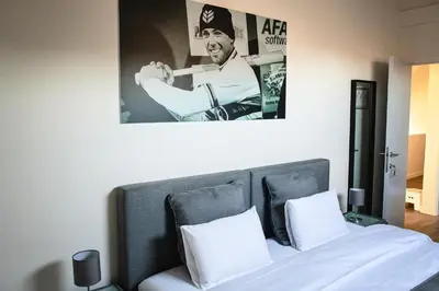 a bedroom with a bed with a poster on the wall at SN Logies in Tremelo